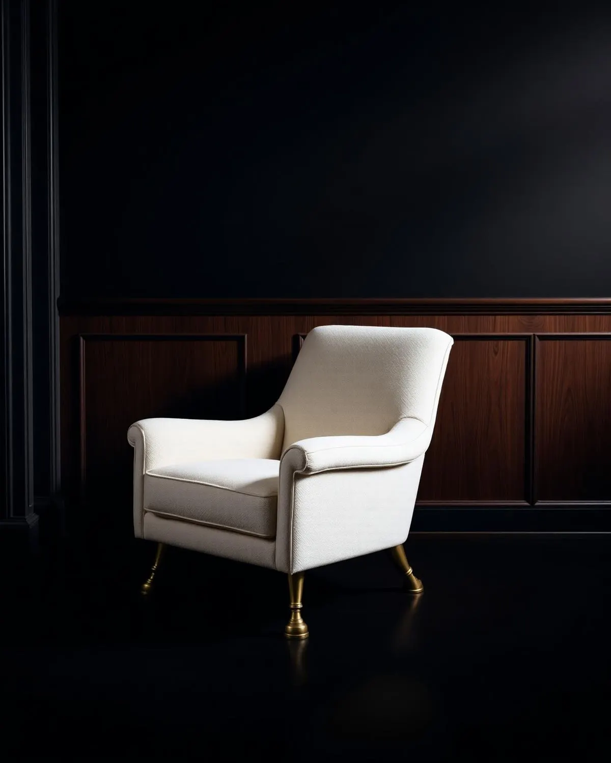 An ivory upholstered armchair on turned brass feet, against walnut panelling