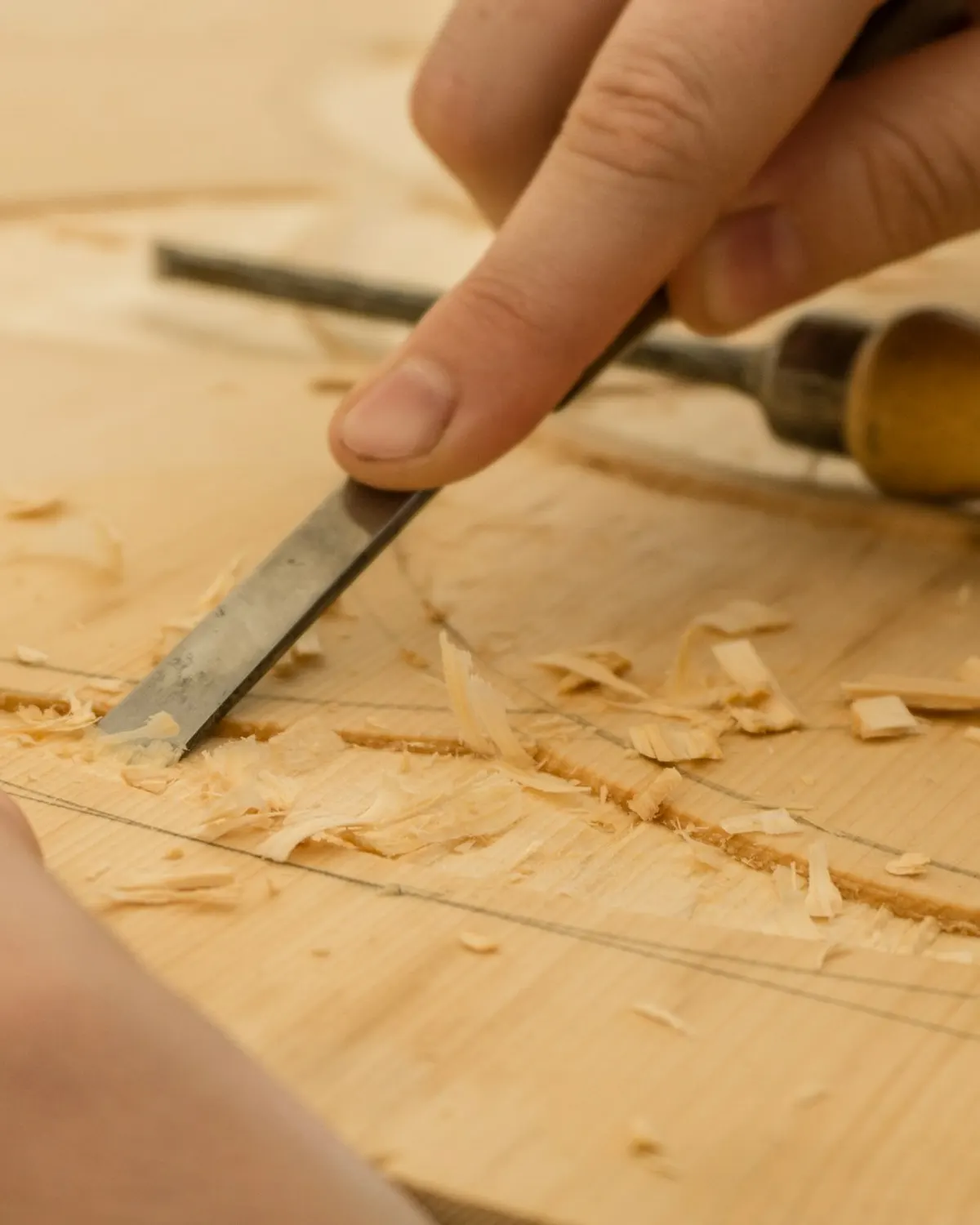 A chisel paring a joint by hand