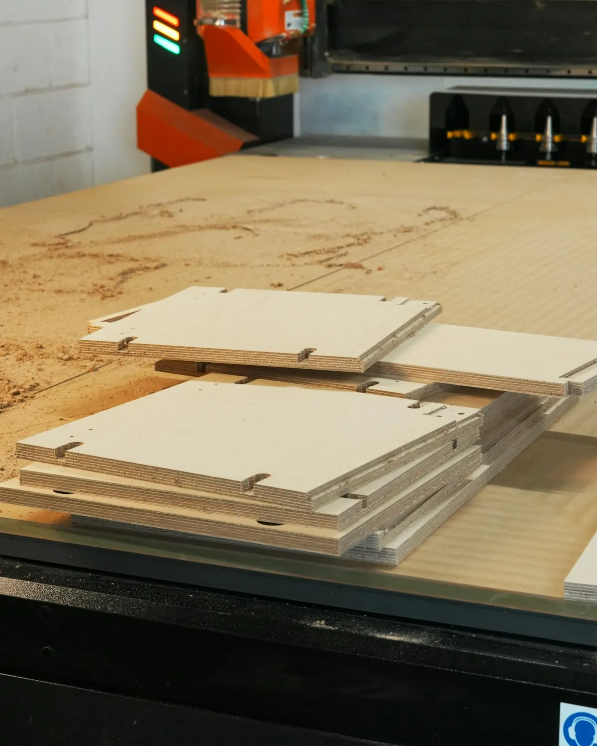 Panels cut to shape on a CNC machine bed
